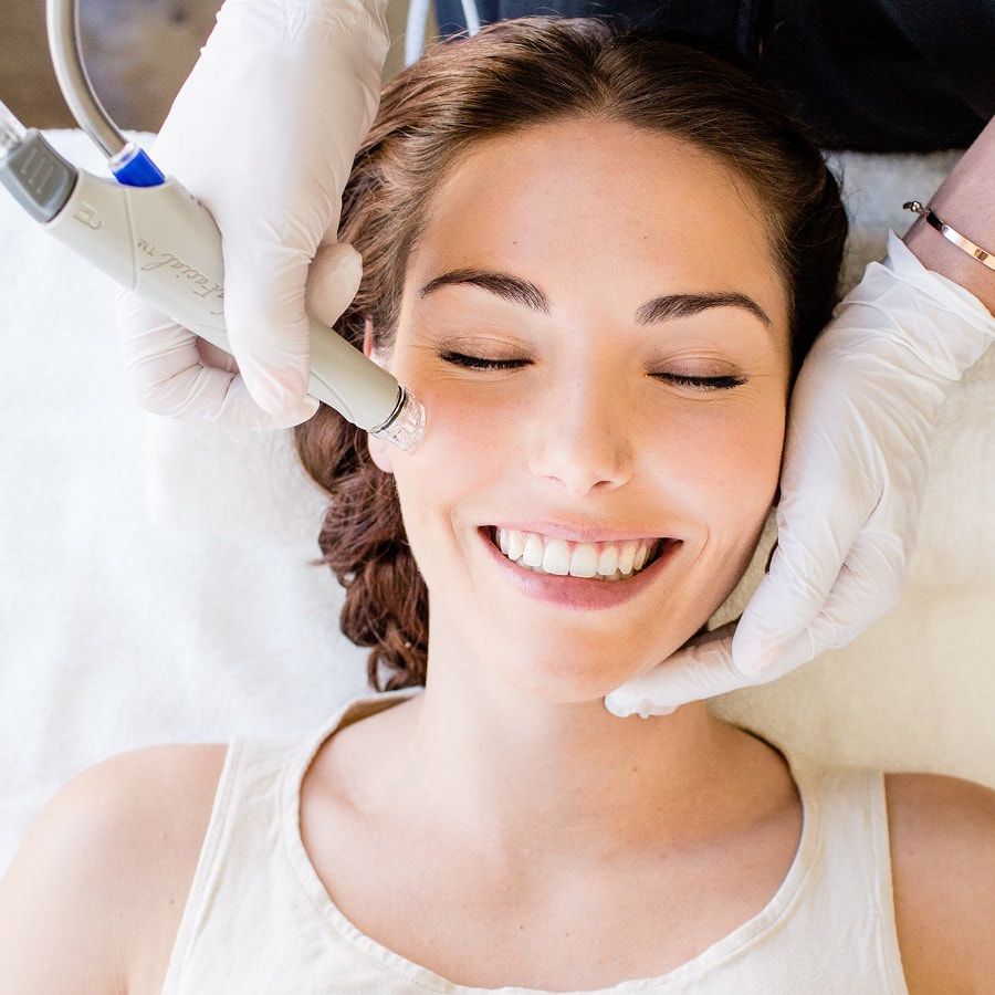 woman closing eyes and smiling while receiving HydraFacial