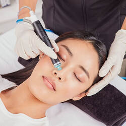 woman getting skin treatment, opens to HydraFacial page